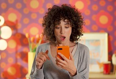 Woman looking at her phone in a Temu advert